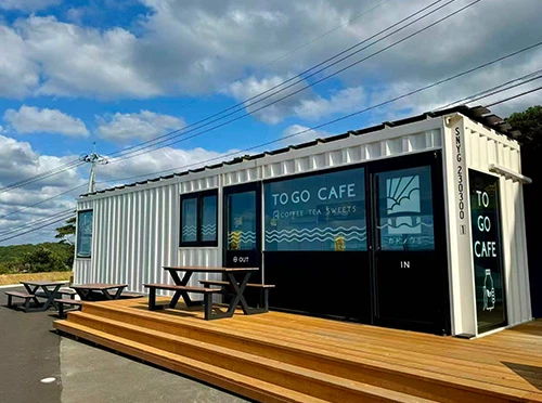 Container coffee shop low-profile design blending with grassy hillside Container coffee shop low-profile design blending with grassy hillside